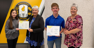 High school students receiving scholarship