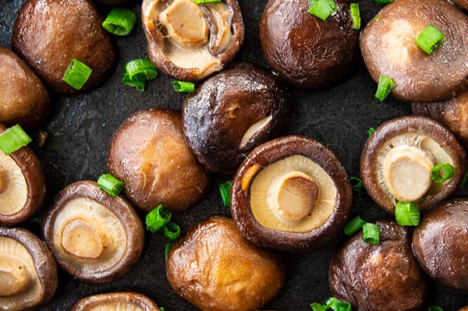 shiitake mushrooms with scallions in a frying pan